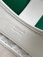 White Goyard tote bag close-up of embossed logo and stitched seam on strap