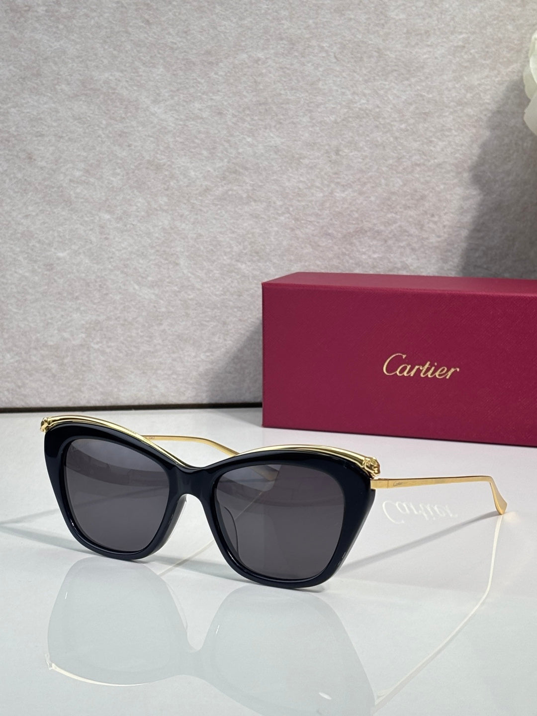 Cartier sunglasses with black frame and gold-tone accents
