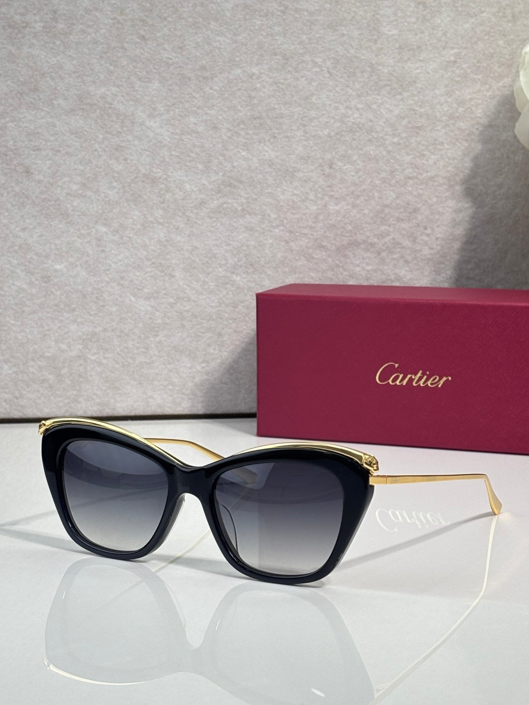 Cartier sunglasses with dark frame and gold-tone temple details