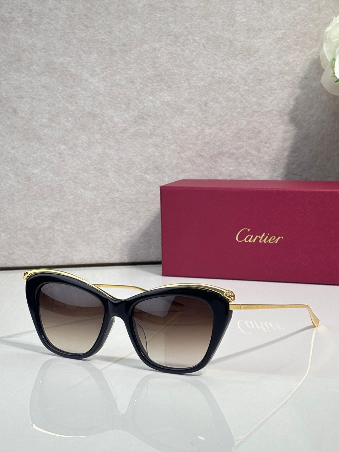 Cartier sunglasses with black frame and dark tinted lenses