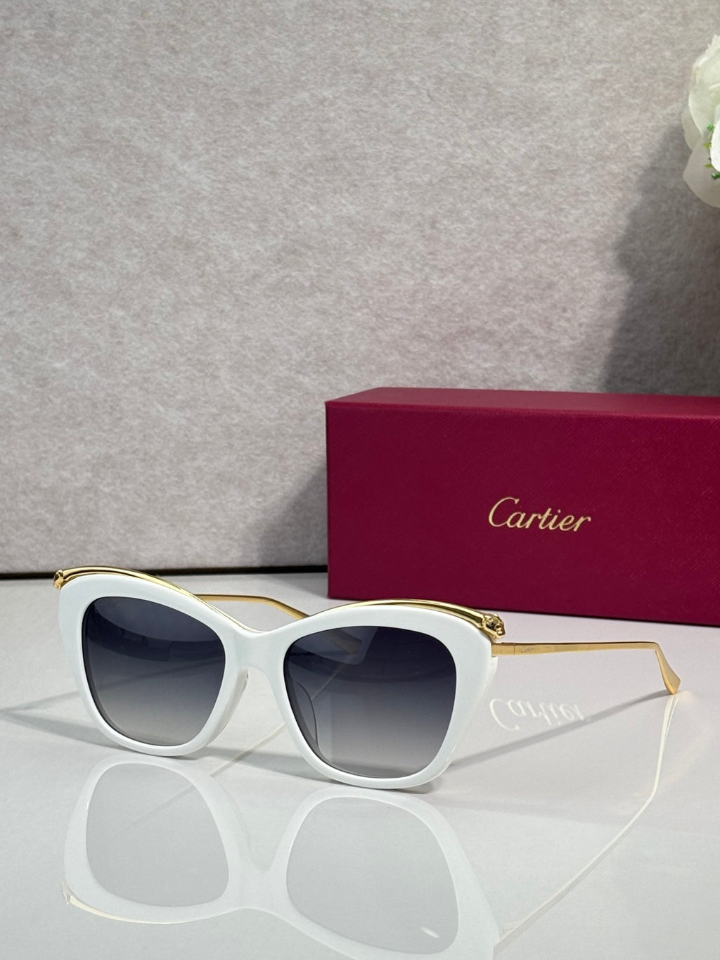Cartier sunglasses with white frame and dark tinted lenses