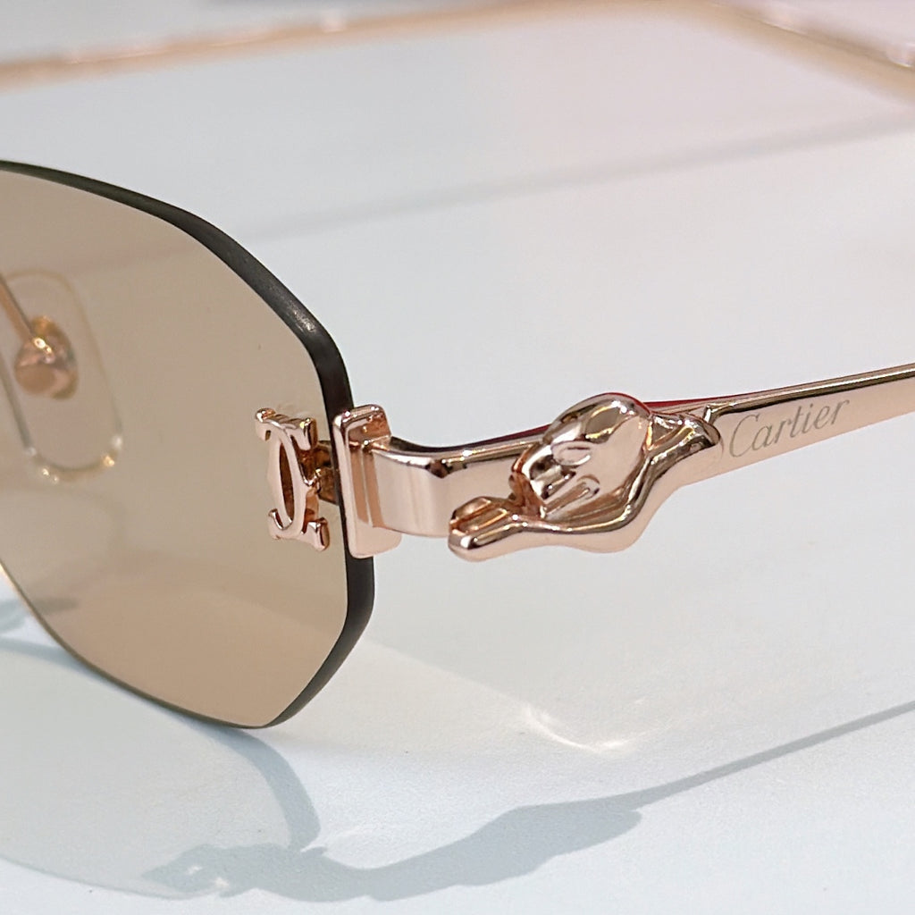 Cartier glasses close-up, rose-gold arms and dark lens