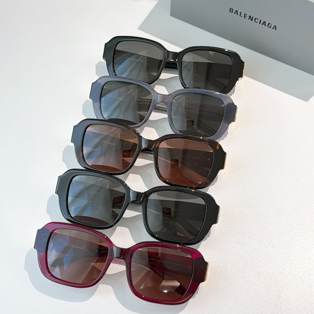 Stacked square sunglasses in dark, gray, brown, and burgundy with gold accents.