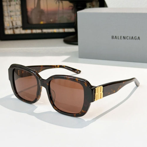 Sunglasses, dark tortoiseshell square frames with gold bar accents.