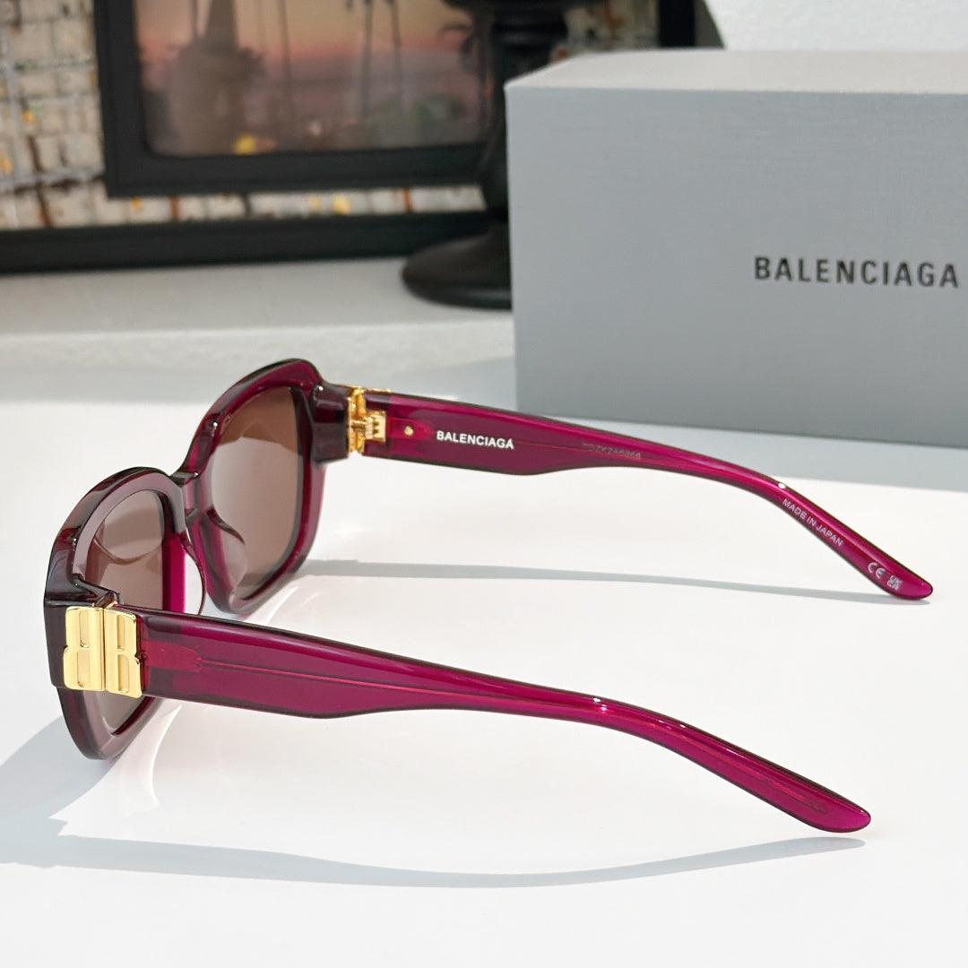 Burgundy sunglasses side view with gold bar hinges and square tinted lenses.