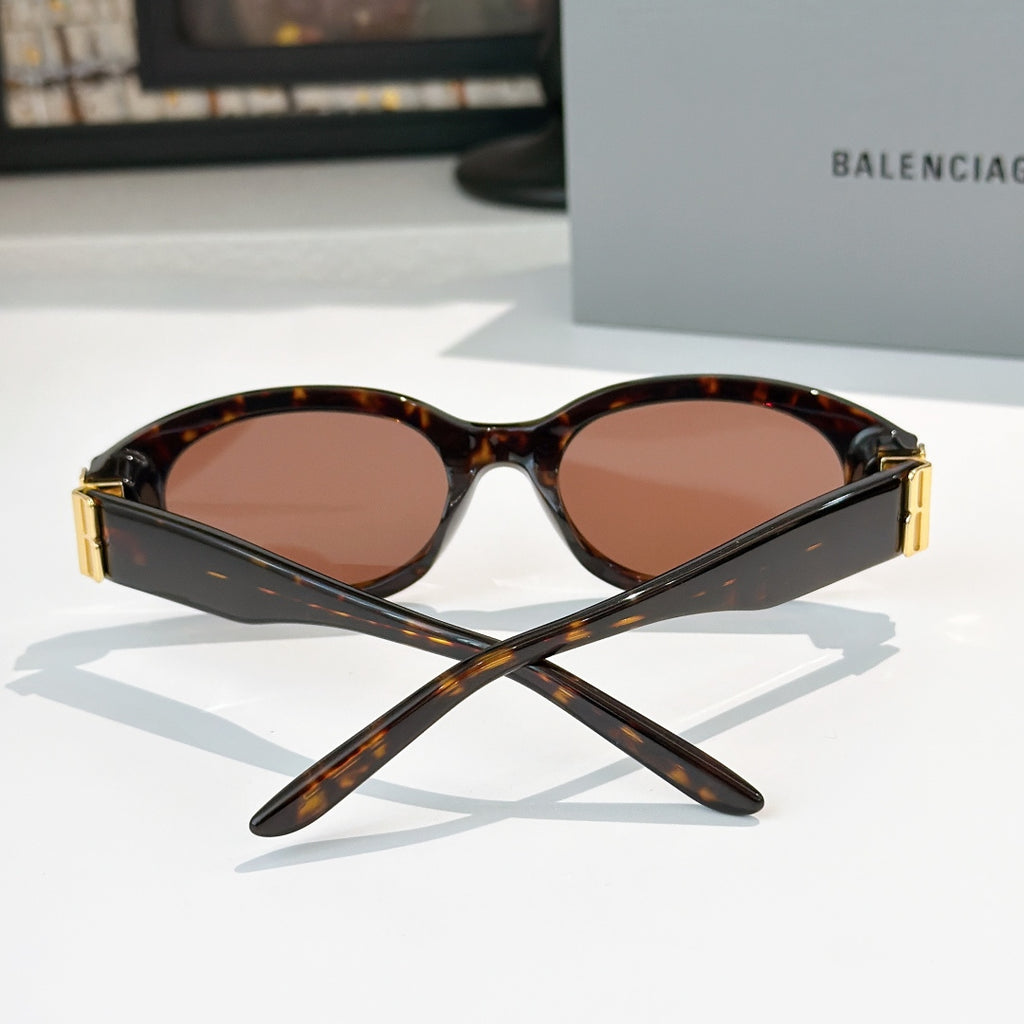 Tortoiseshell cat-eye sunglasses with brown tinted lenses and gold hinge detail