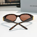 Tortoiseshell cat-eye sunglasses with brown tinted lenses and gold hinge detail