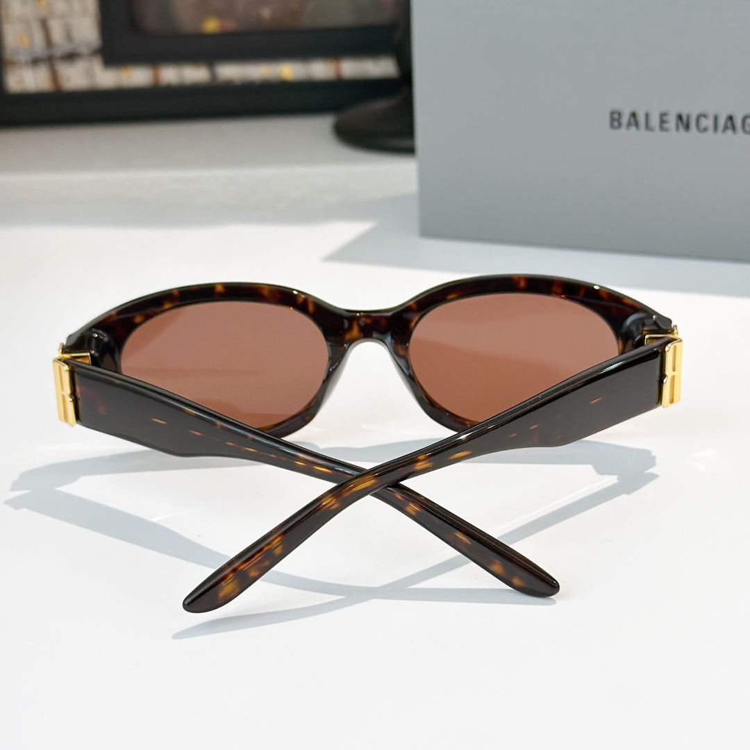 Tortoiseshell cat-eye sunglasses with brown tinted lenses and gold hinge detail