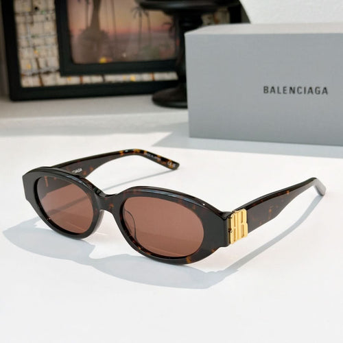 Tortoiseshell cat-eye sunglasses with brown tinted lenses and gold bridge detail