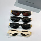 Set of cat-eye sunglasses with tinted lenses and gold-tone hinge details
