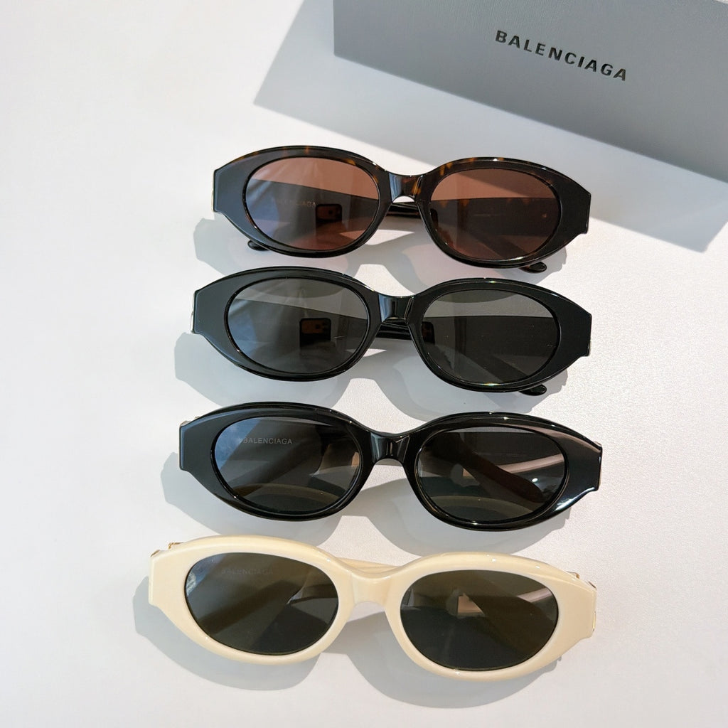 Group of cat-eye sunglasses in black, tortoiseshell, and cream with tinted lenses