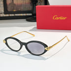 Black eyeglasses with gold temples and light gray-tinted lenses, round-to-cat-eye style.