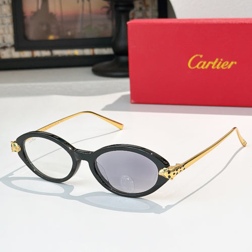 Black eyeglasses with gold temples and light gray-tinted lenses, round-to-cat-eye style.