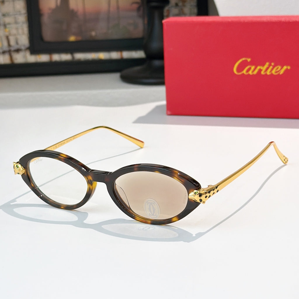 Tortoise eyeglasses with gold temples and beige-tinted lenses, round-to-cat-eye style.