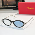 Black eyeglasses with gold temples and blue-tinted lenses, round-to-cat-eye style.