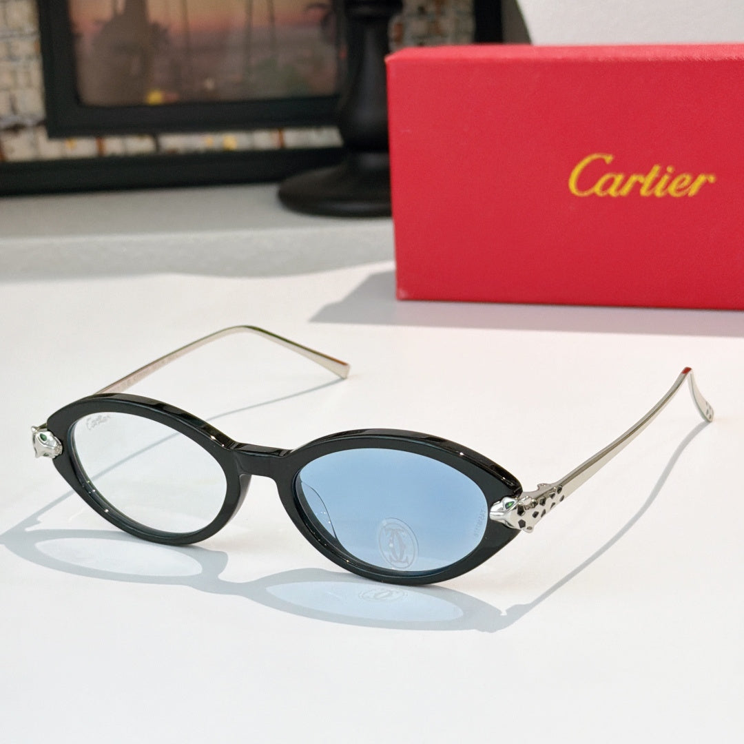 Black eyeglasses with gold temples and blue-tinted lenses, round-to-cat-eye style.