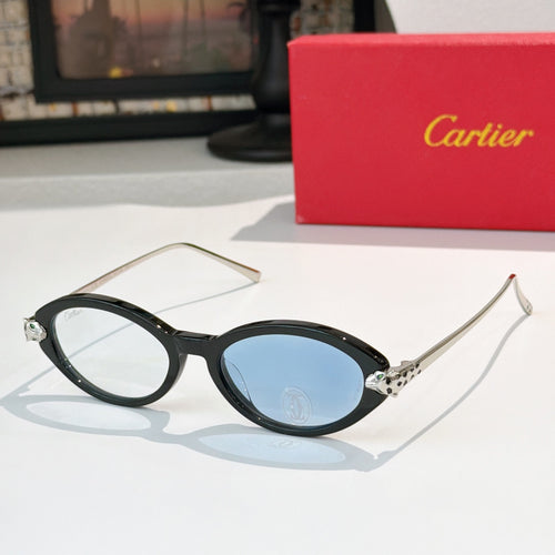 Black eyeglasses with gold temples and blue-tinted lenses, round-to-cat-eye style.