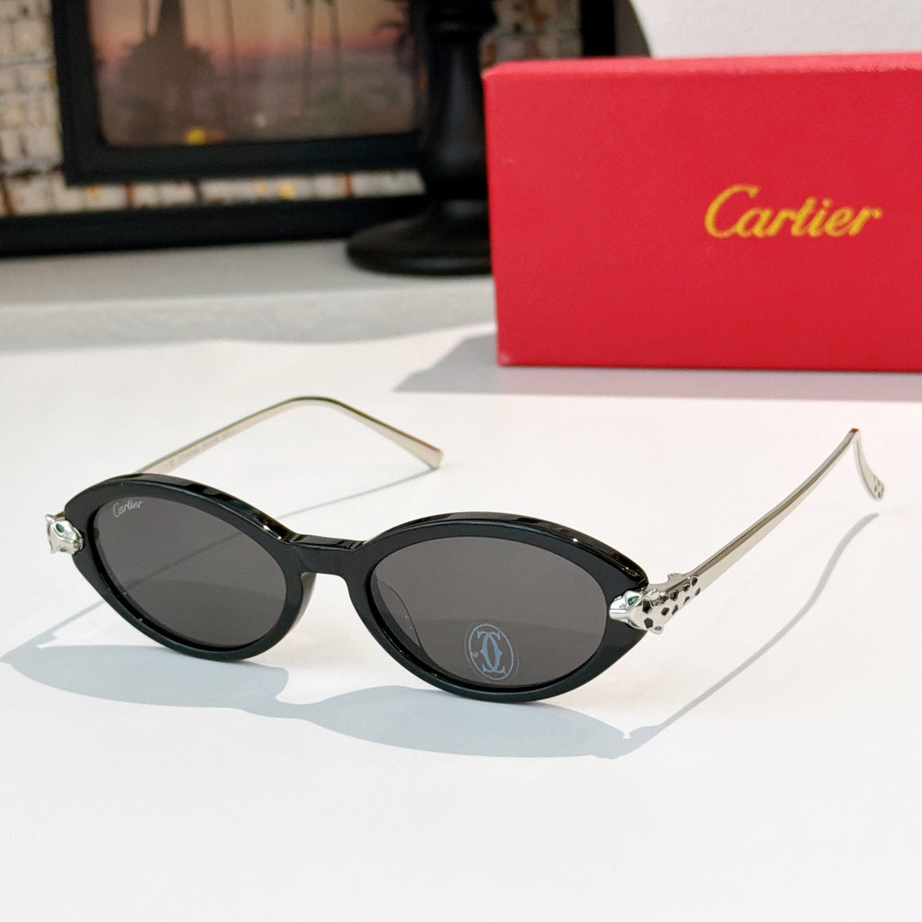 Black eyeglasses with gold temples and dark gray lenses, round-to-cat-eye style.