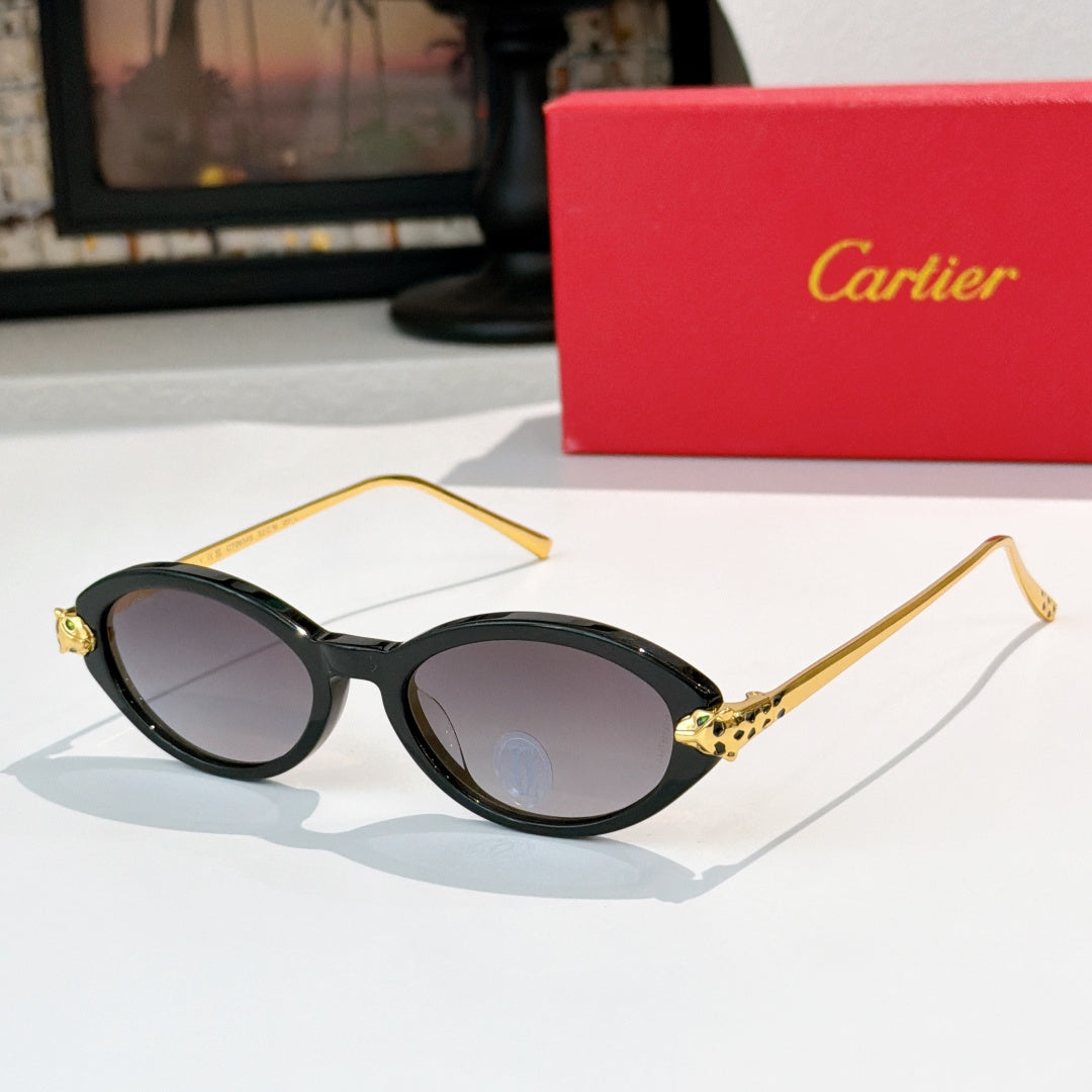 Black eyeglasses with gold temples and dark purple-tinted lenses, round-to-cat-eye style.