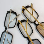 Cartier glasses set with black frames and gold-tone temples, clear lenses