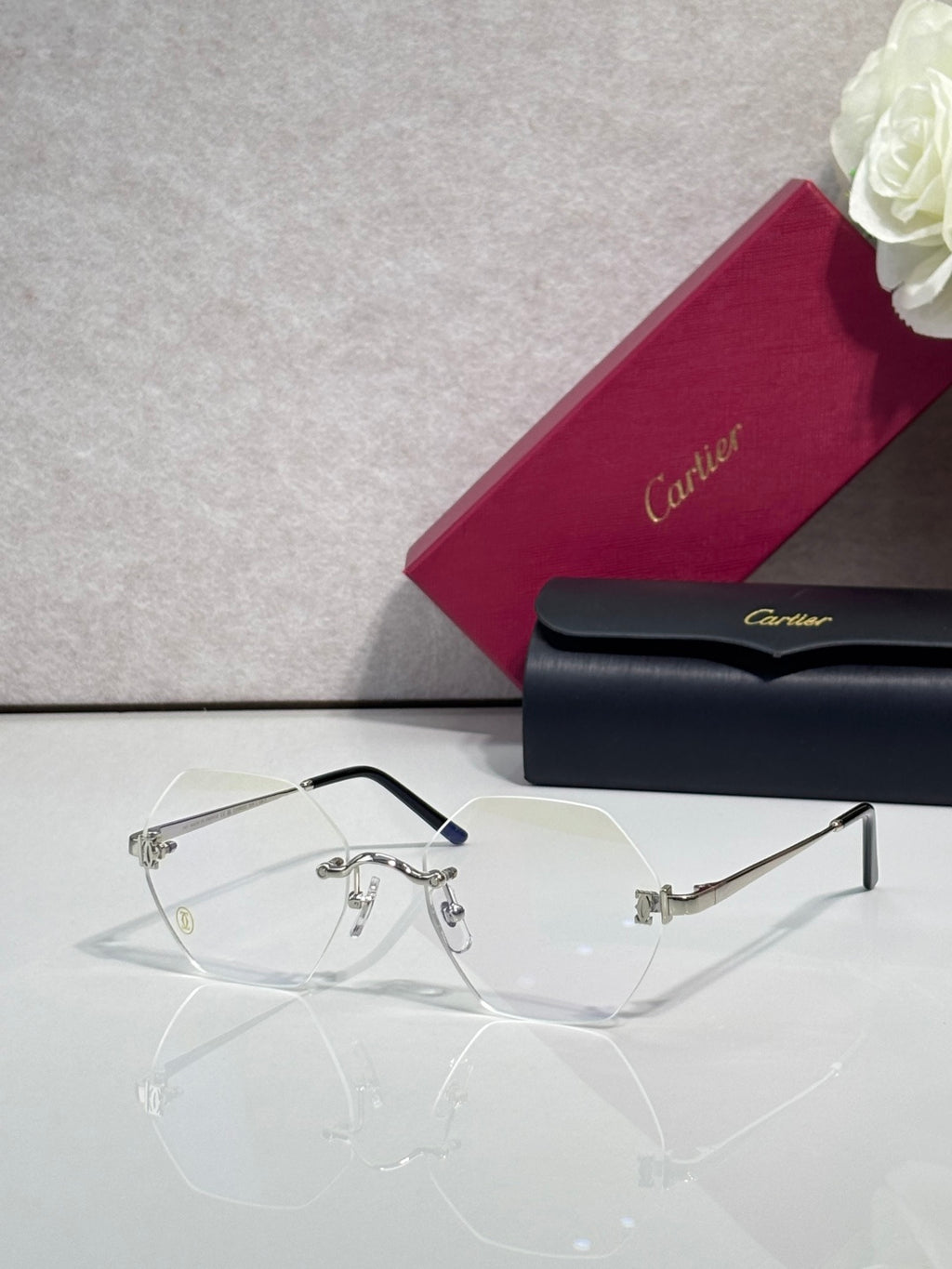Clear eyeglasses with metal hinges and light gray tinted lenses