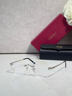 Clear eyeglasses with metal hinges and light gray tinted lenses