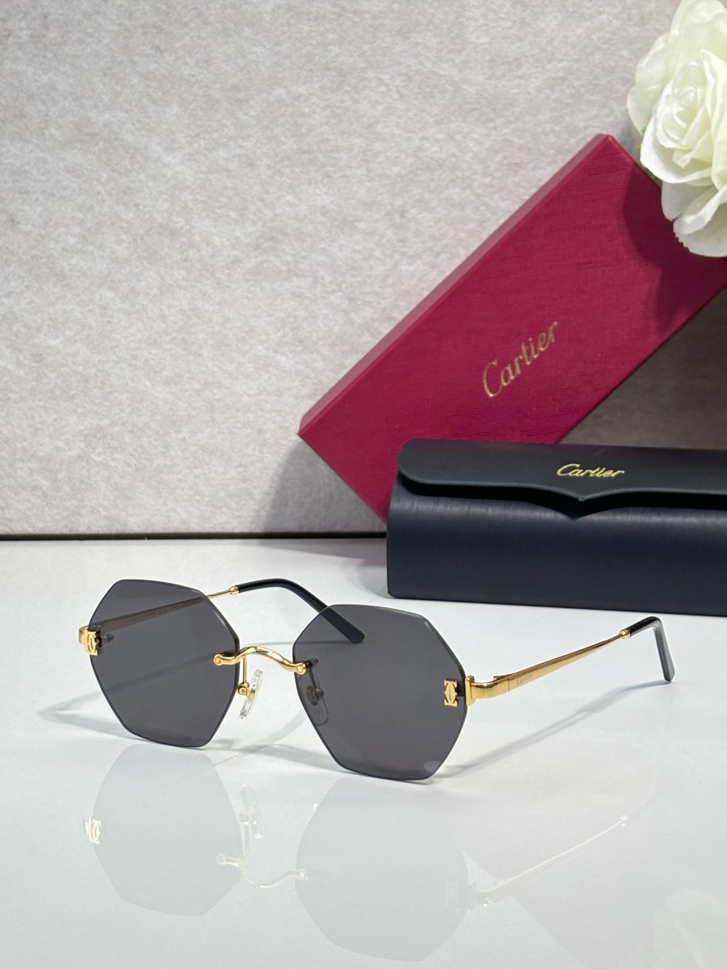 Hexagonal sunglasses with black frame and dark gray tinted lenses
