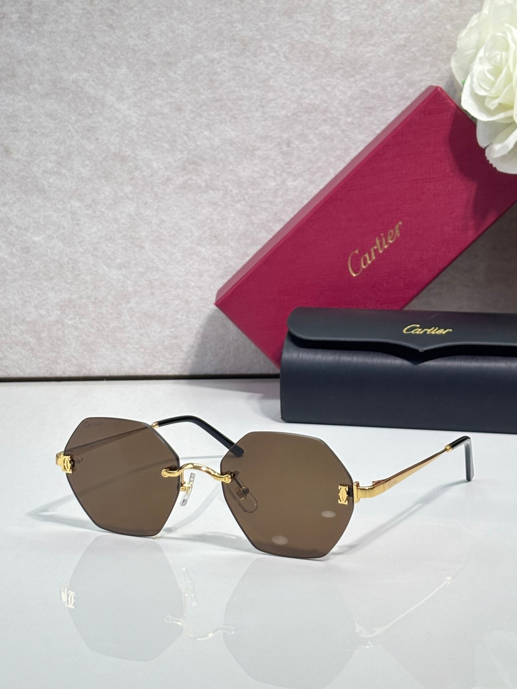 Hexagonal sunglasses with black frame and dark brown tinted lenses