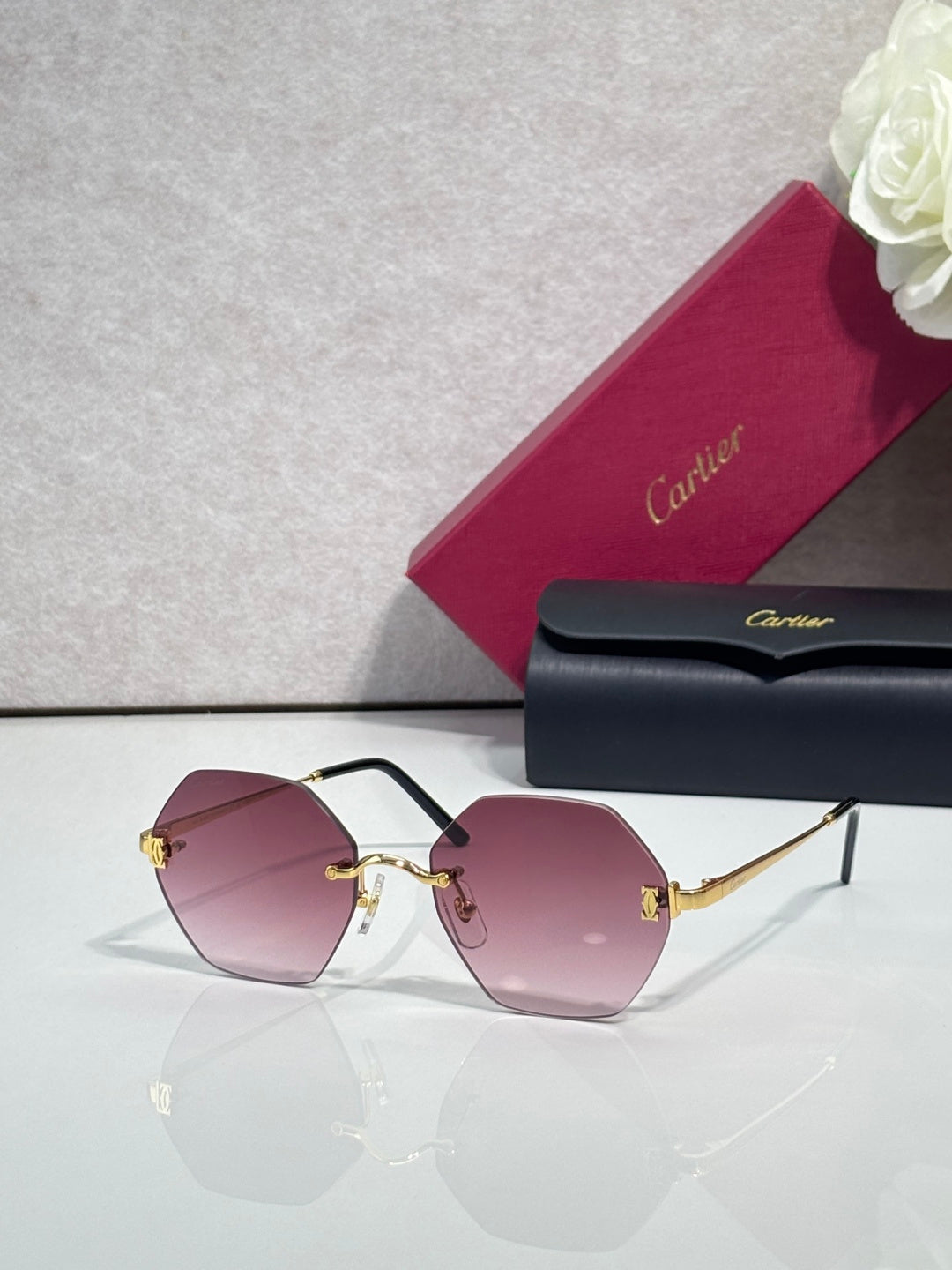 Hexagonal sunglasses with black frame and mauve tinted lenses