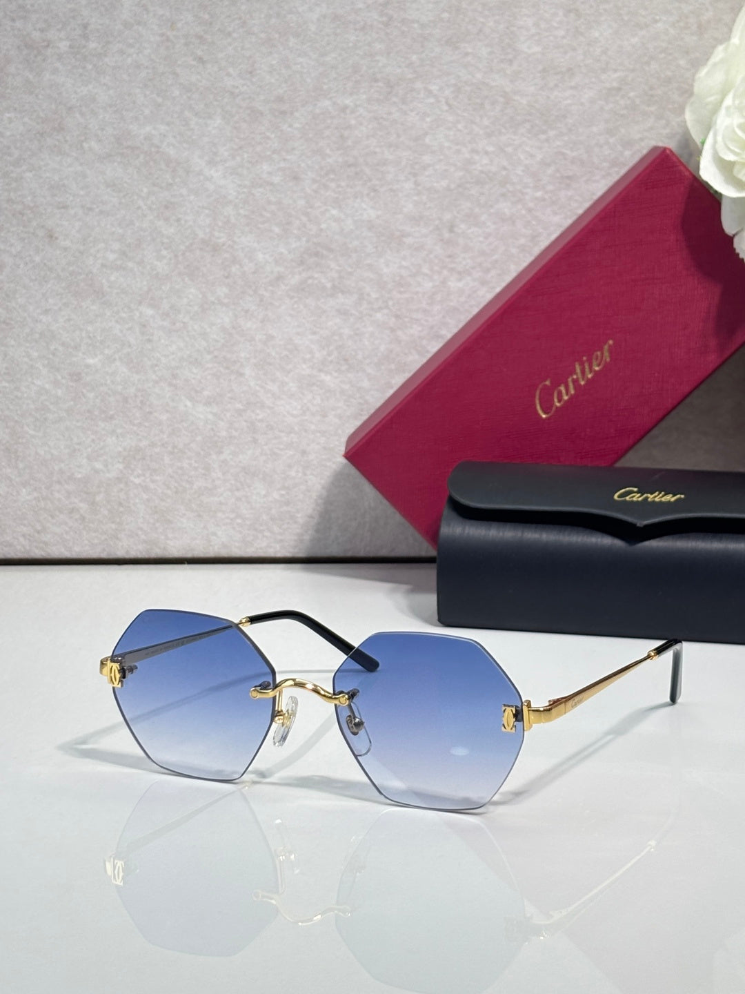 Hexagonal sunglasses with black frame and light blue tinted lenses