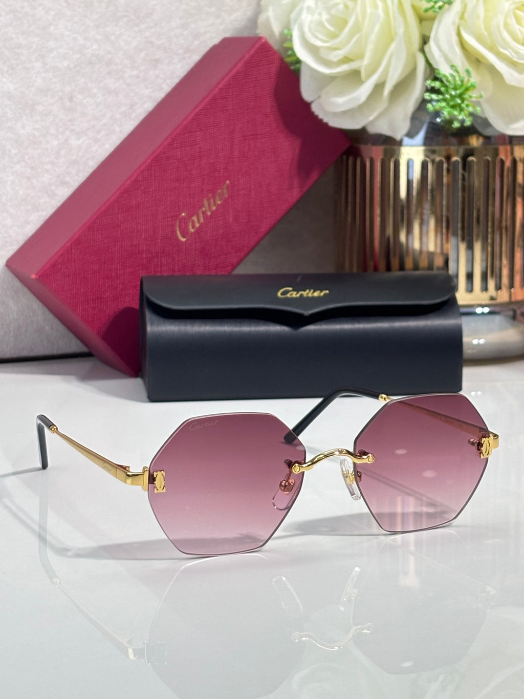 Hexagonal sunglasses with black frame and pink tinted lenses