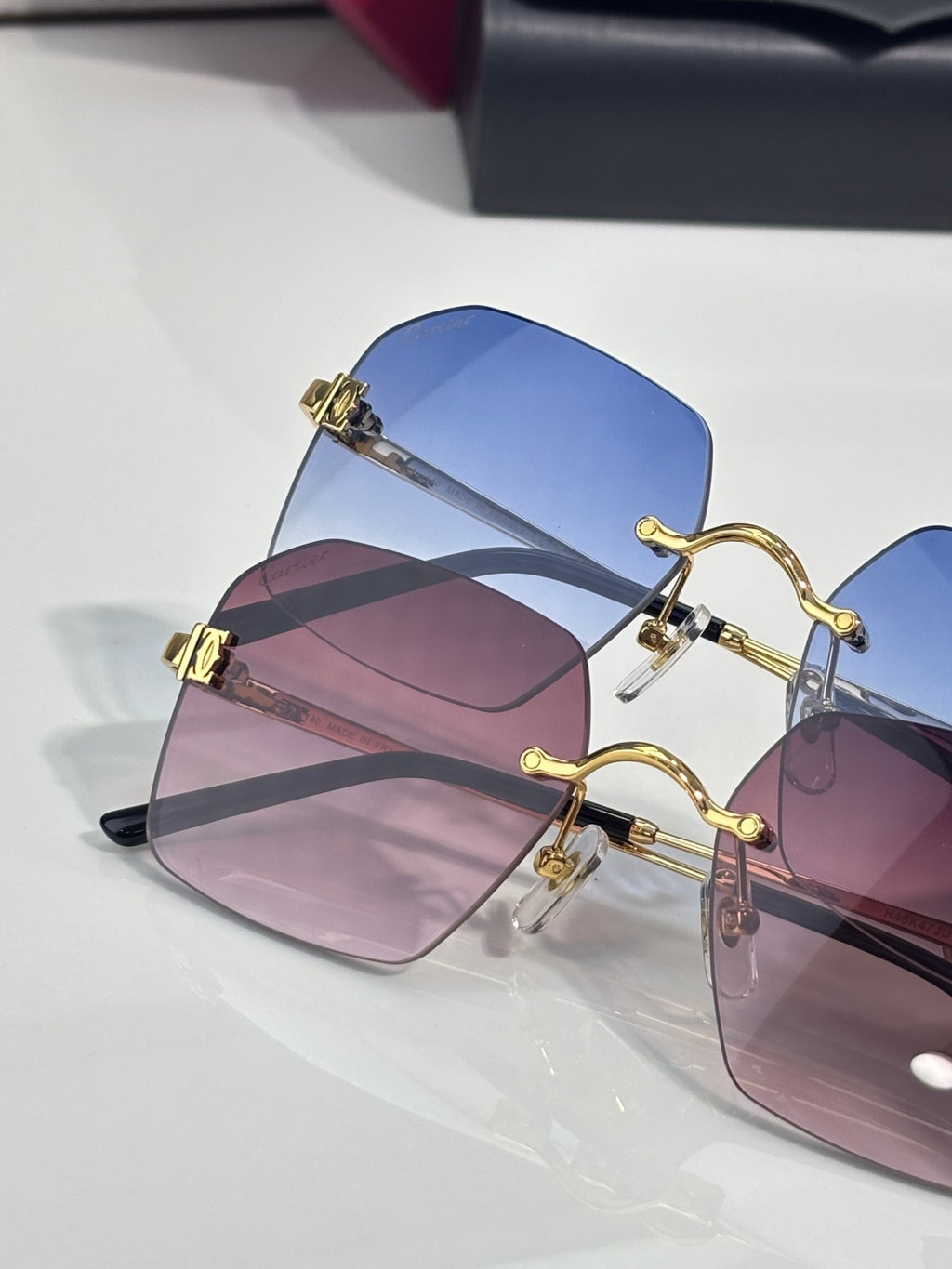 Cartier glasses featuring blue and pink-tinted lenses with gold-tone frames