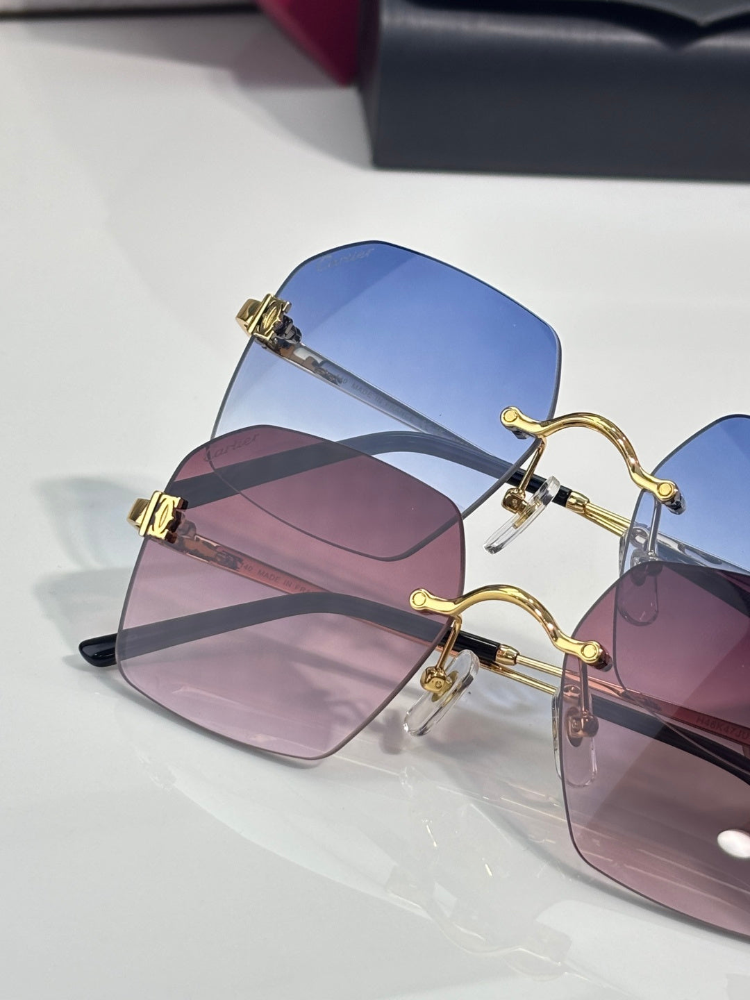 Cartier glasses featuring blue and pink-tinted lenses with gold-tone frames