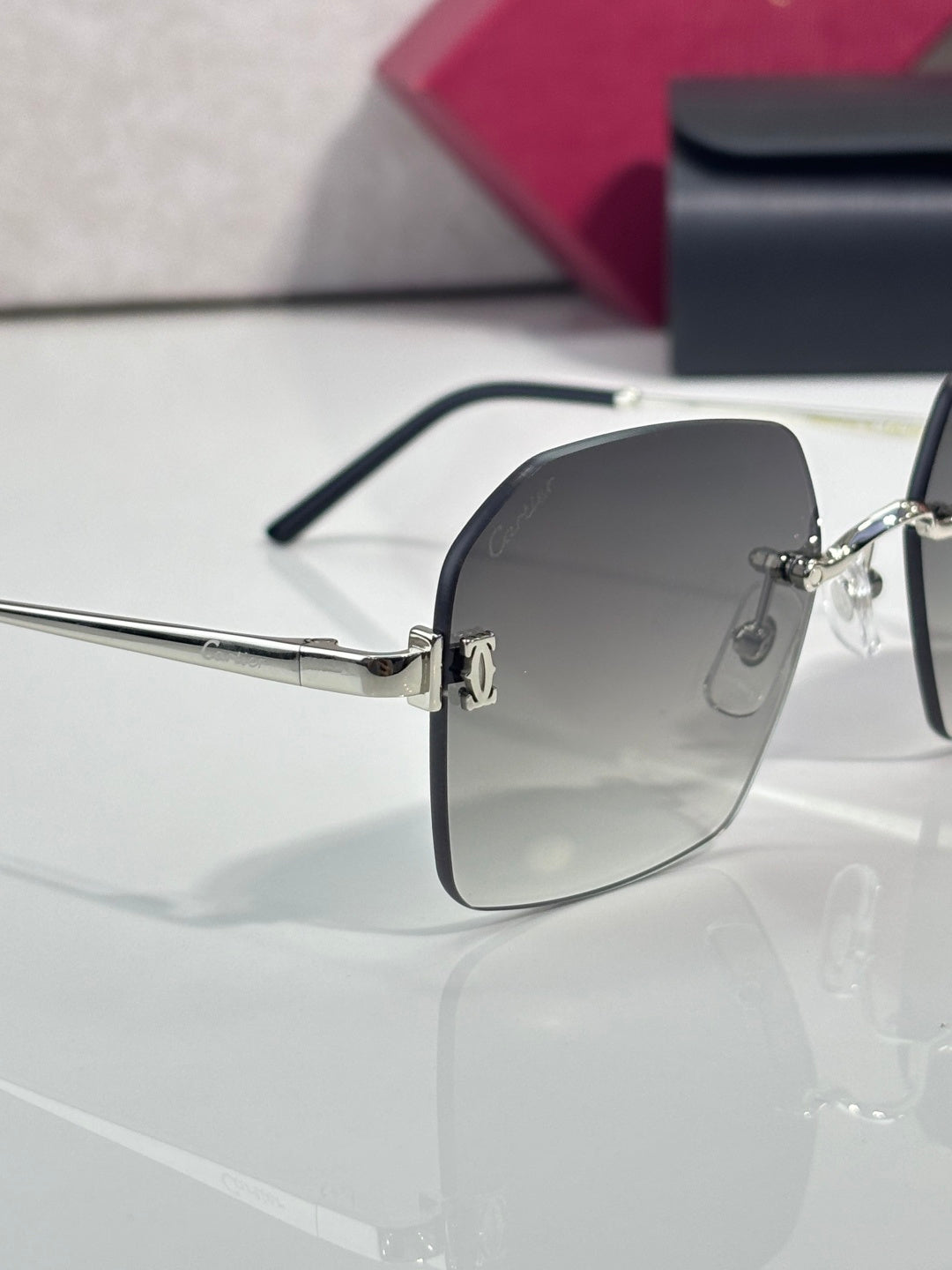 Cartier glasses with dark gray lenses, silver frame, and black temple tips