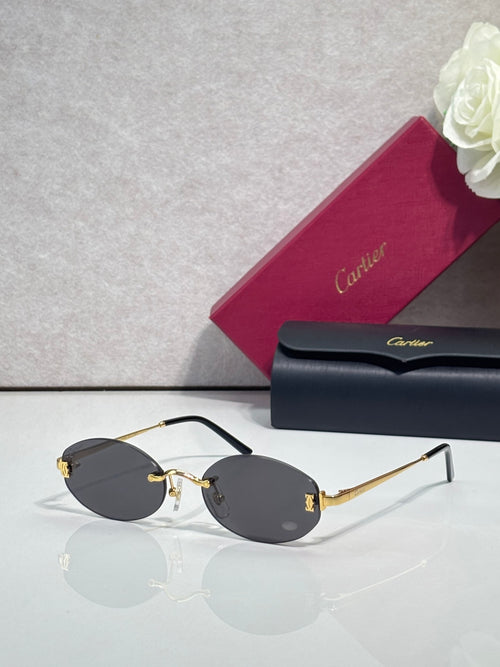 Round sunglasses with gold frame, dark temples, and gray tinted lenses