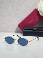 Round sunglasses with gold frame, dark temples, and blue tinted lenses