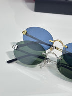 Round sunglasses with gold frame and blue-green tinted lenses
