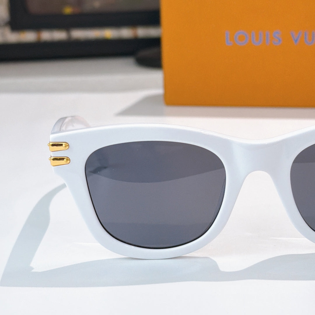 White cat-eye sunglasses with dark tinted lens and gold LV logo on temple arm.