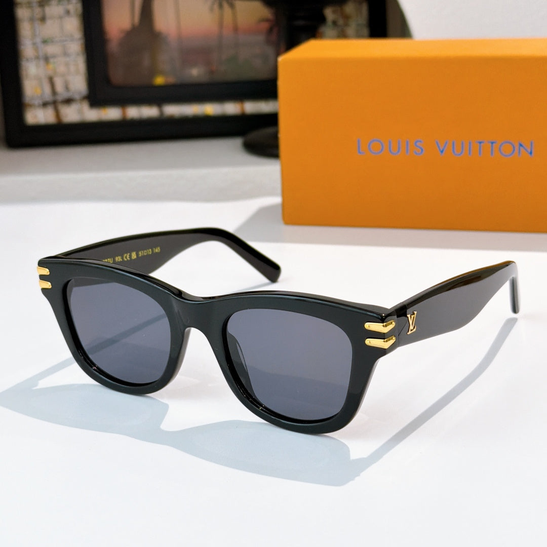 Cat-eye sunglasses with dark frames and cool-toned tinted lenses, gold LV logo on temples.