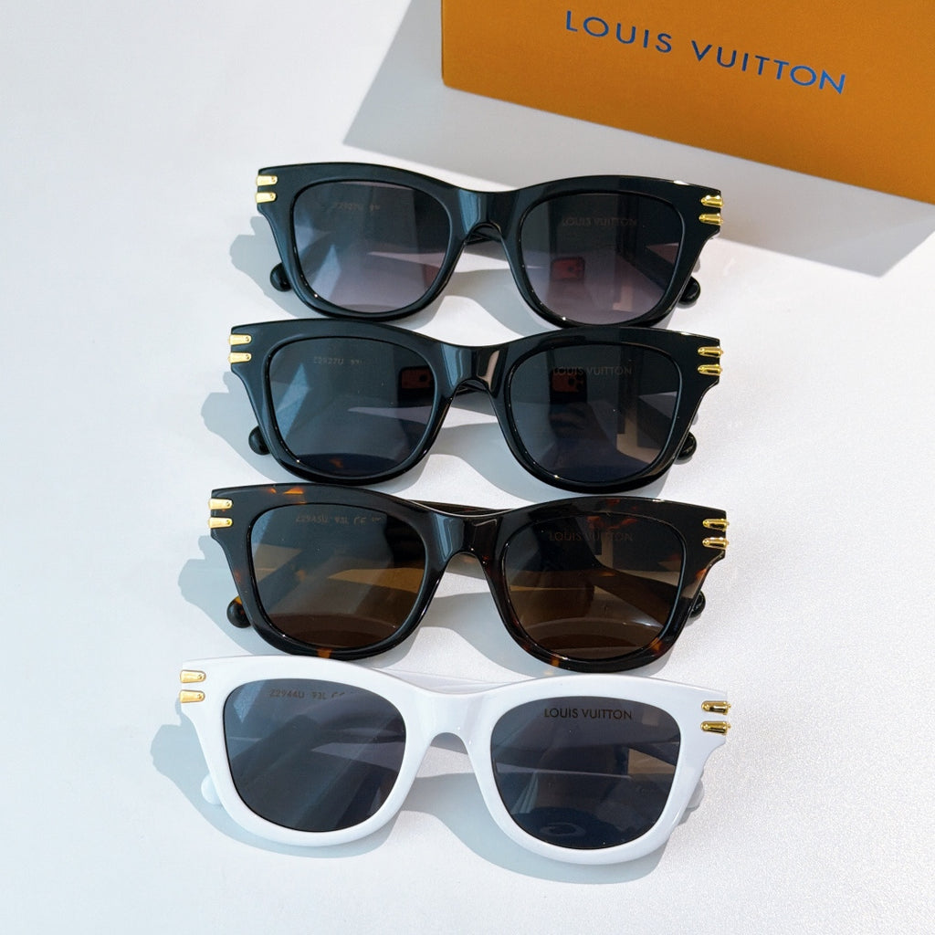 Set of cat-eye sunglasses in dark and white frames with tinted lenses and gold LV logo accents.