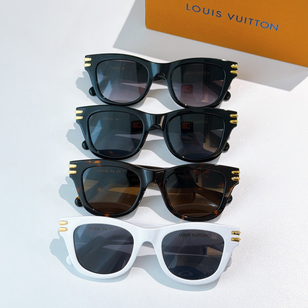 Set of cat-eye sunglasses in dark and white frames with tinted lenses and gold LV logo accents.