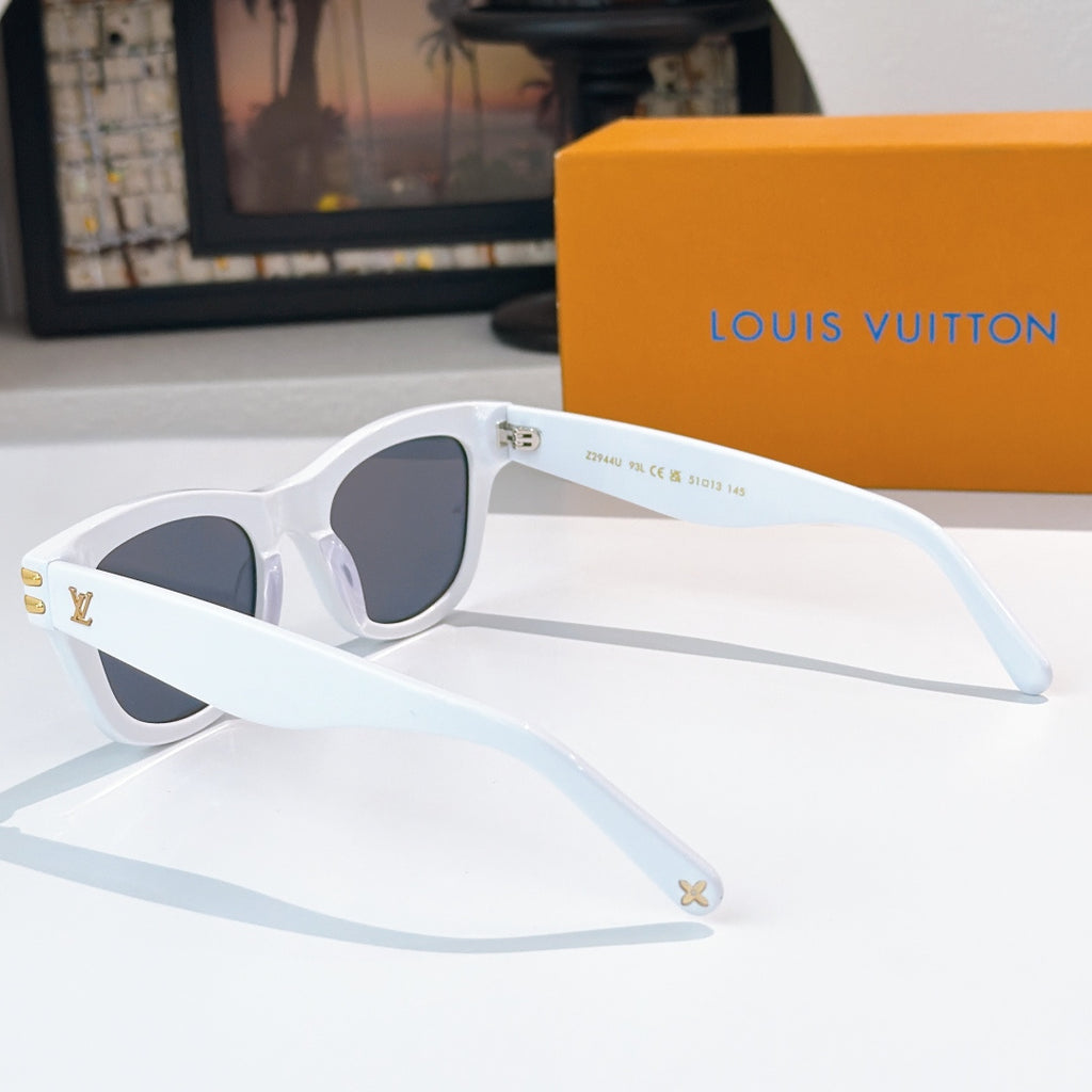 White cat-eye sunglasses with dark tinted lenses and gold LV logo accents on temples.