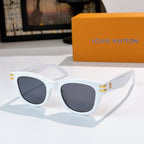 Cat-eye sunglasses with white frames, dark tinted lenses, and gold LV logo on temples.