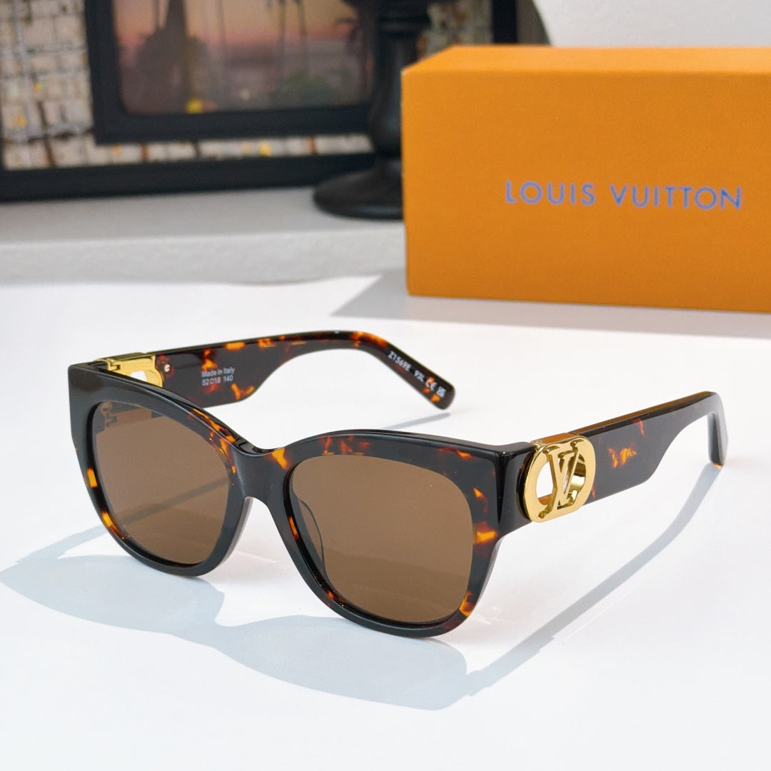 Black cat-eye sunglasses with tortoise temples, gold LV logo accents, brown lenses