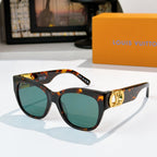 Black cat-eye sunglasses with tortoise temples, gold LV logo, teal tinted lenses
