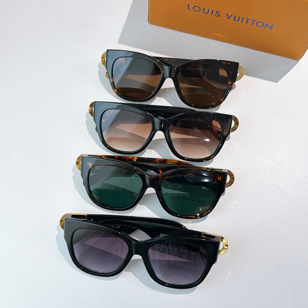 Stack of black cat-eye sunglasses with gold LV accents and assorted tinted lenses