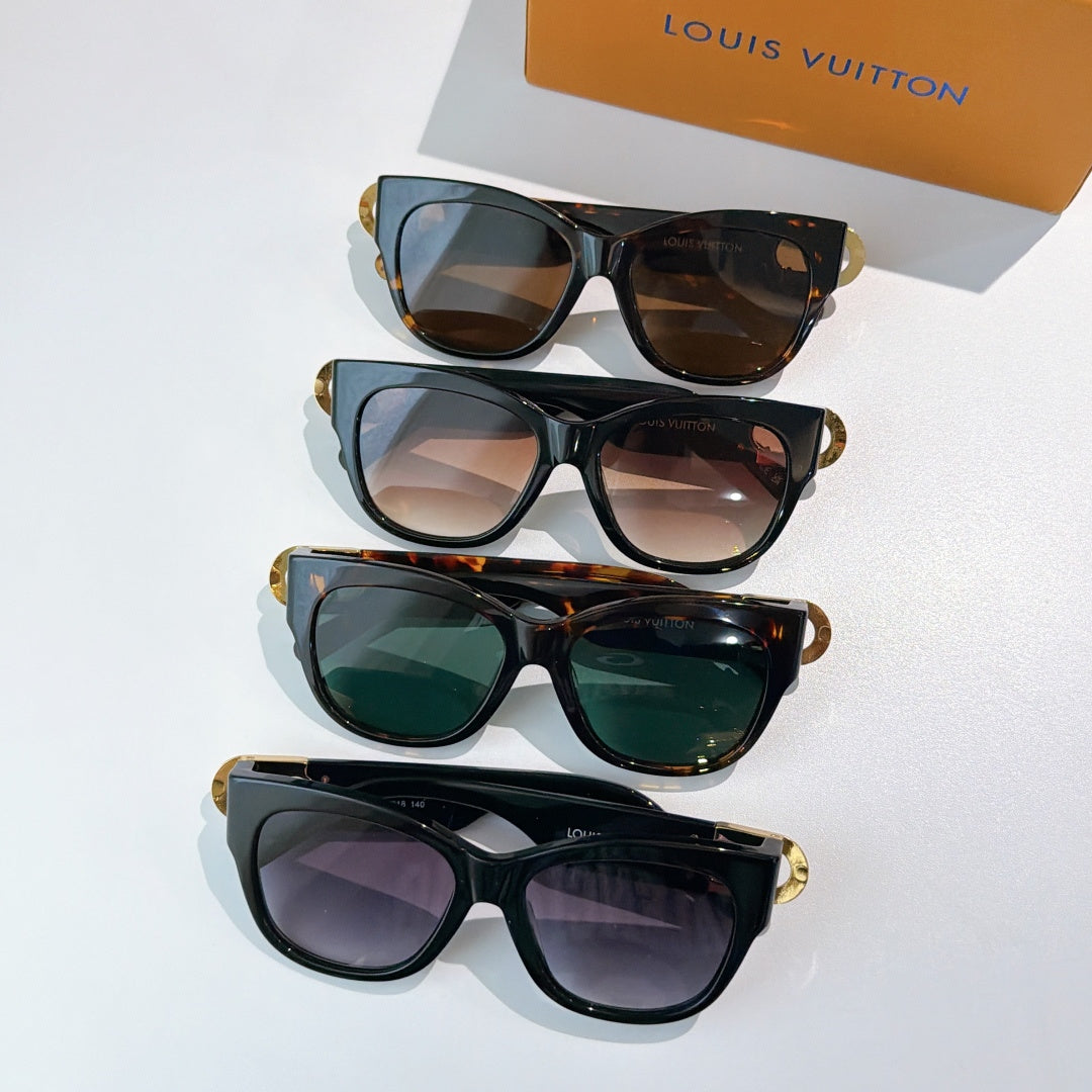 Stack of black cat-eye sunglasses with gold LV accents and assorted tinted lenses