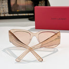 Sunglasses with translucent peach frames and light rose lenses, cat-eye shape.