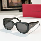 Sunglasses with black frames and dark tinted lenses, cat-eye shape.