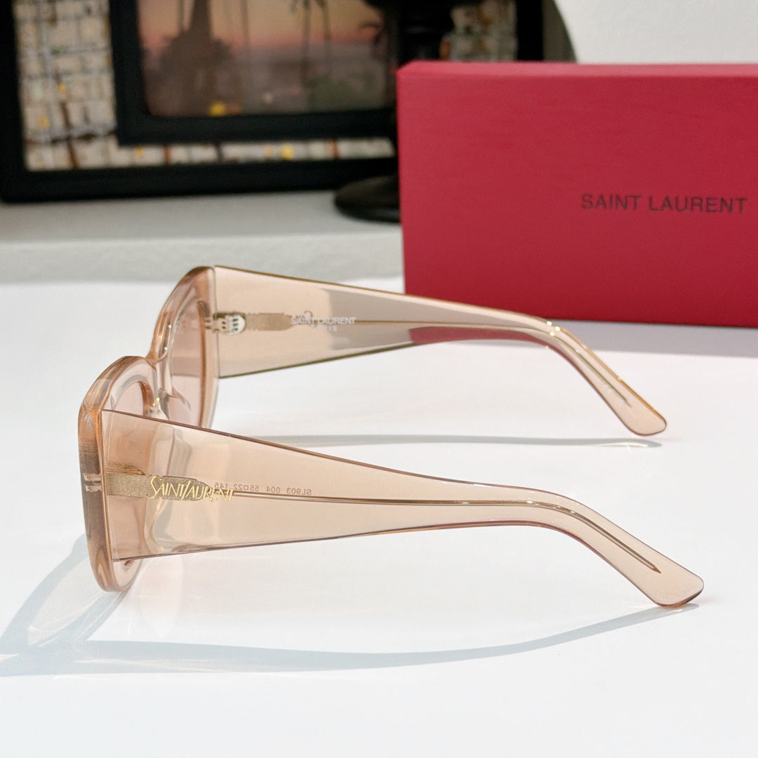 Sunglasses with translucent peach frames and clear lenses, side view.